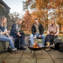 Round Cast Iron Outdoor Fire Pit with Black Finish on Tripod On Sale